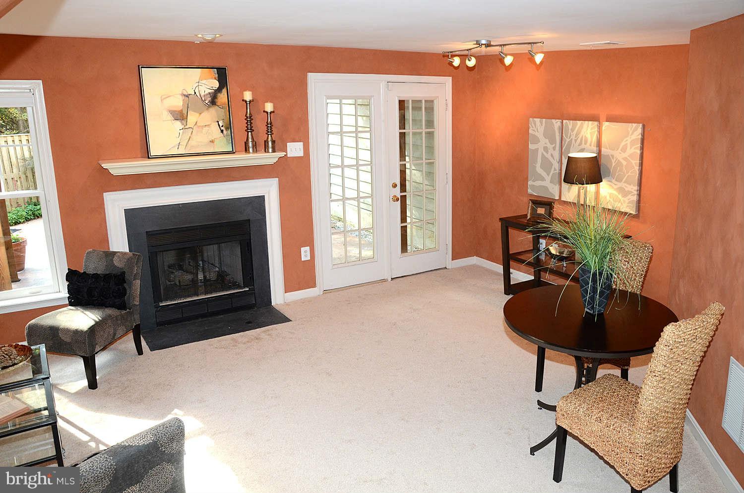 1267 Weatherstone Court Reston, VA 20194 - Photo 24 of 30 a living room with furniture and a fireplace