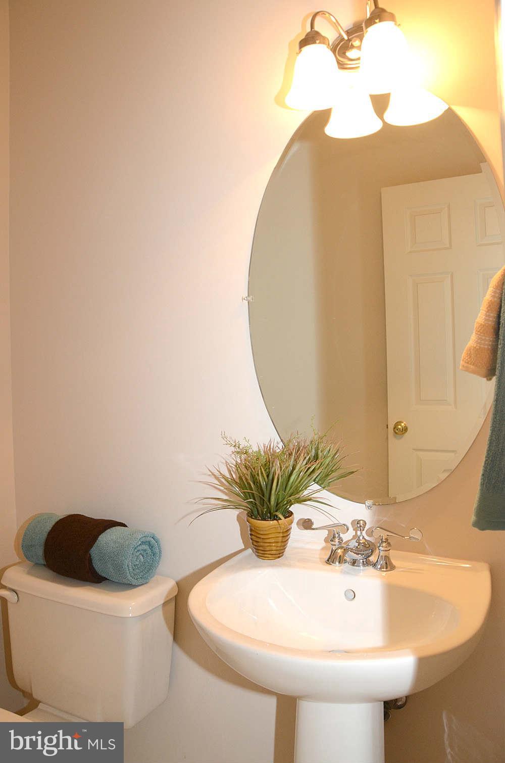 1267 Weatherstone Court Reston, VA 20194 - Photo 8 of 30 a bathroom with a sink a toilet and a mirror
