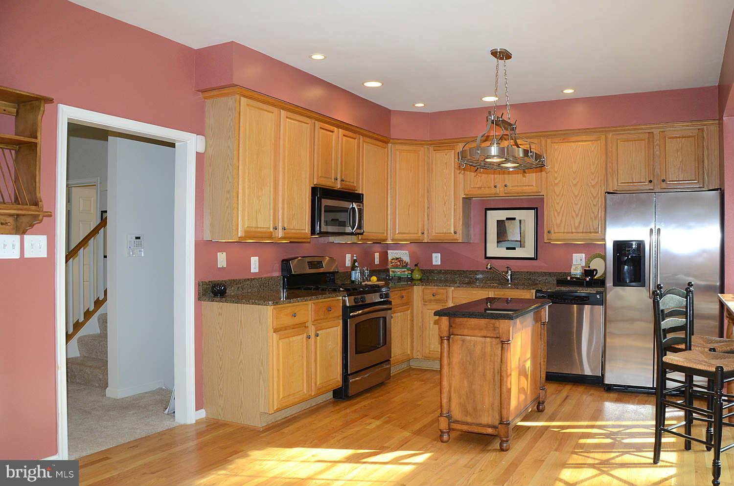 1267 Weatherstone Court Reston, VA 20194 - Photo 9 of 30 a kitchen with stainless steel appliances granite countertop a sink stove and refrigerator