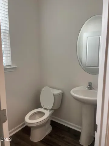 a white toilet sitting next to a bathroom sink