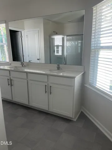 a bathroom with a glass shower door