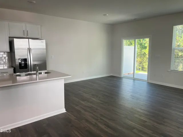 a view of a kitchen with wooden floor and a sink