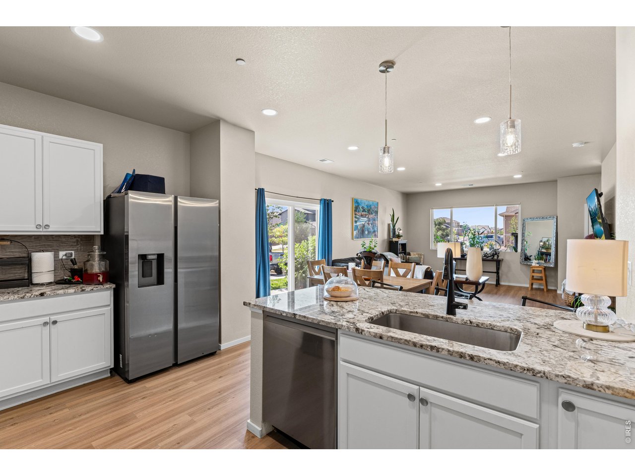 Kitchen opens to dining room and living room with lots of natural light.
