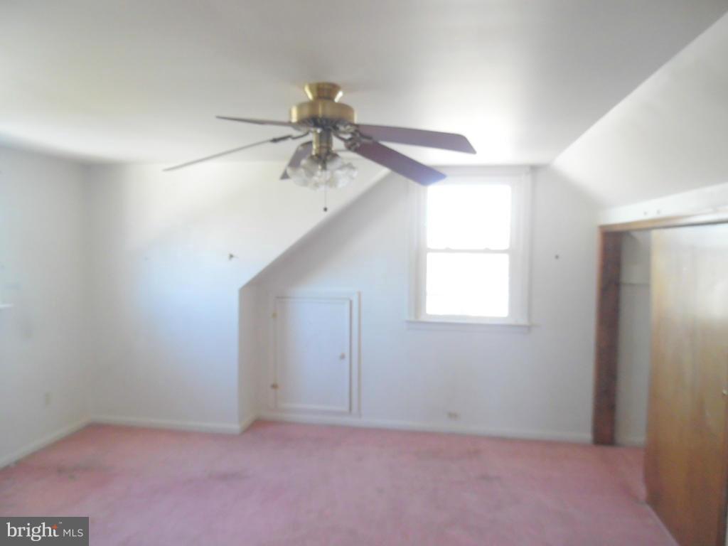 2422 Plainfield Road Dundalk, MD 21222 - Photo 13 of 14 an empty room with a window and a fan