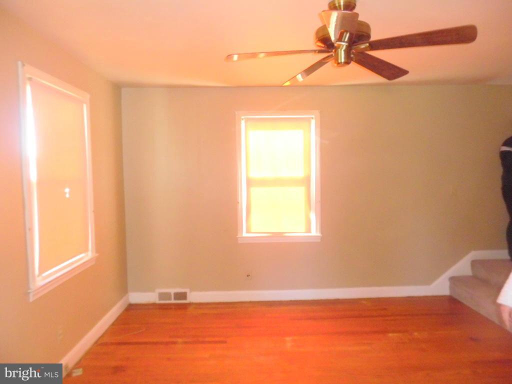 2422 Plainfield Road Dundalk, MD 21222 - Photo 6 of 14 an empty room with a window and a fan