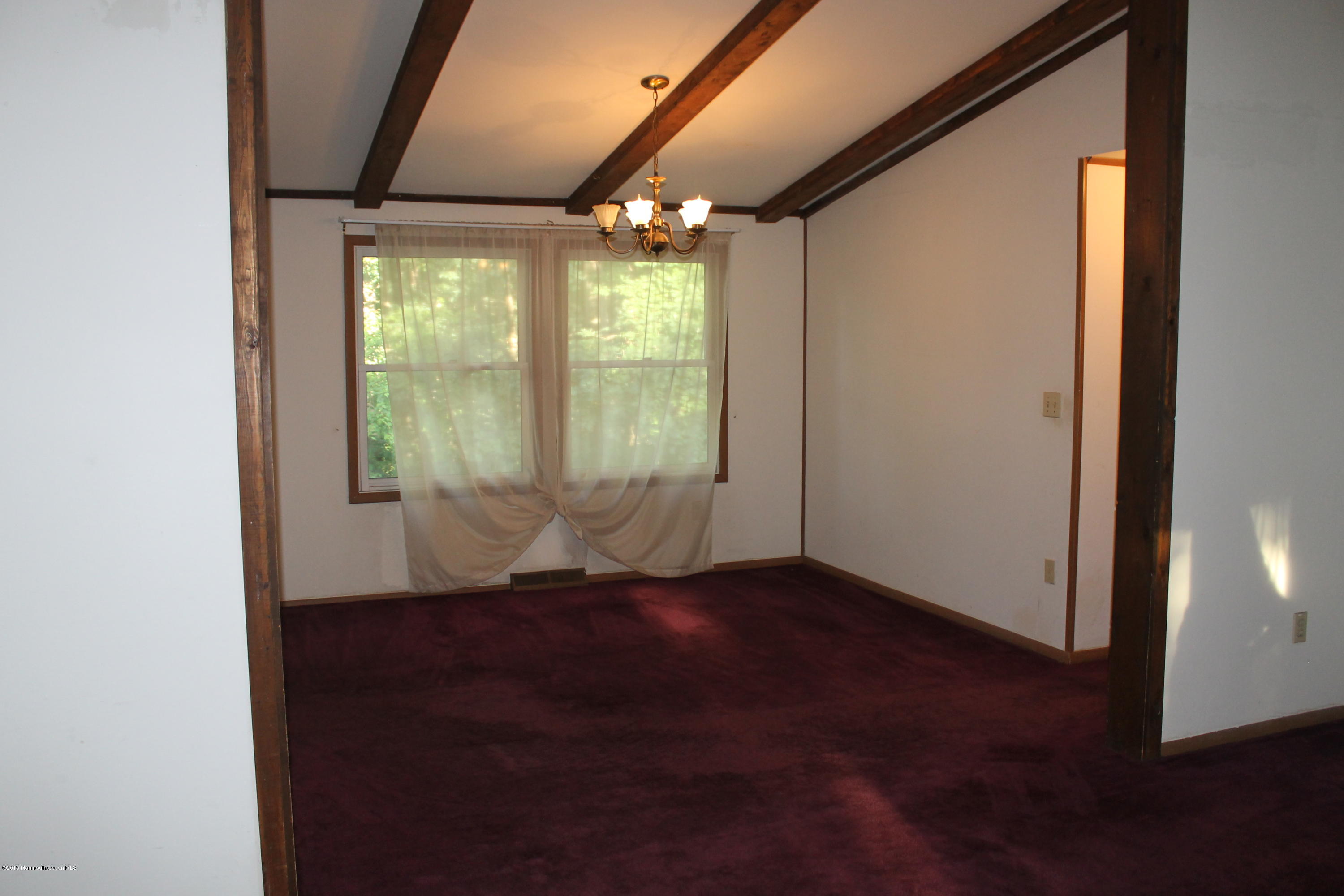 185 Cedar Swamp Road Jackson, NJ 08527 - Photo 7 of 36 an empty room with wooden floor and windows