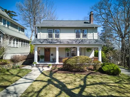 a view of a house with backyard porch and sitting area