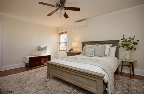 a large bed sitting in a bedroom next to a window