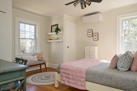 a white toilet sitting next to a bathroom sink and a mirror
