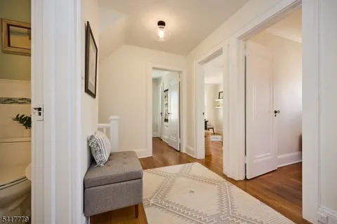 a living room with a rug and wooden floor