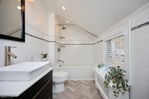 a front view of a house with a yard and tree s