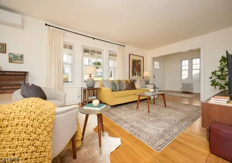 a living room with furniture a fireplace and a table
