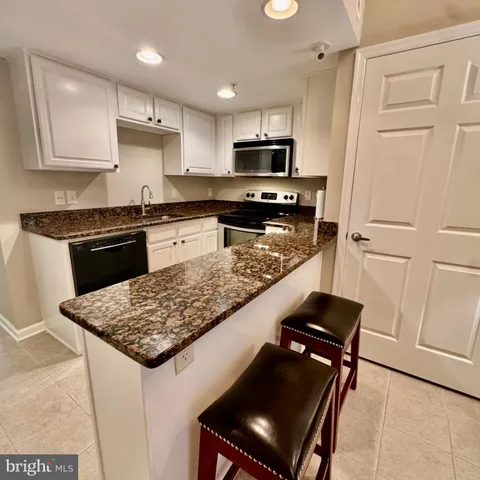 a kitchen with a stove sink and refrigerator