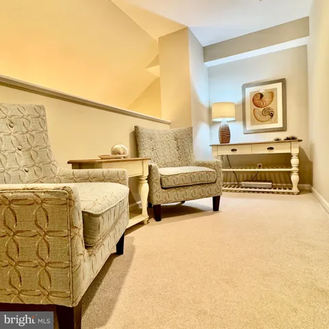 a spacious bedroom with a bed and painting on the wall