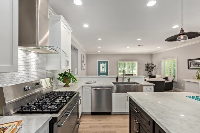a kitchen with lots of counter top space stove sink and cabinets