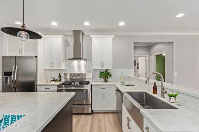 a kitchen with granite countertop a sink stainless steel appliances and counter space
