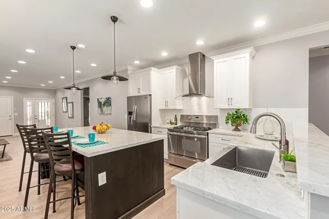 a kitchen with a table chairs stove and white cabinets
