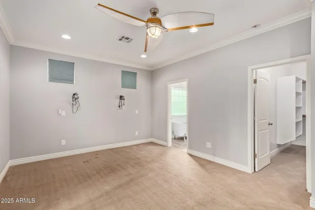 a view of a livingroom with a chandelier fan and windows