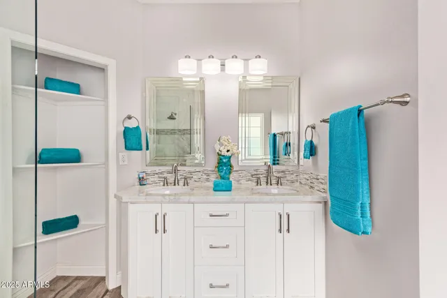 a bathroom with a double vanity sink and mirror