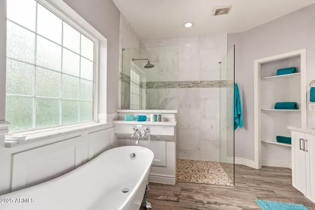 a bathroom with a tub sink and mirror