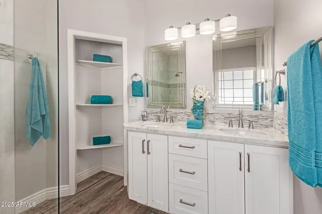 a bathroom with a sink double vanity and a mirror