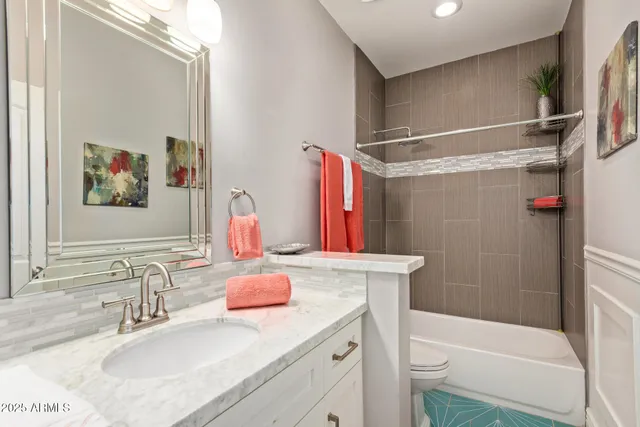a bathroom with a sink vanity granite and toilet