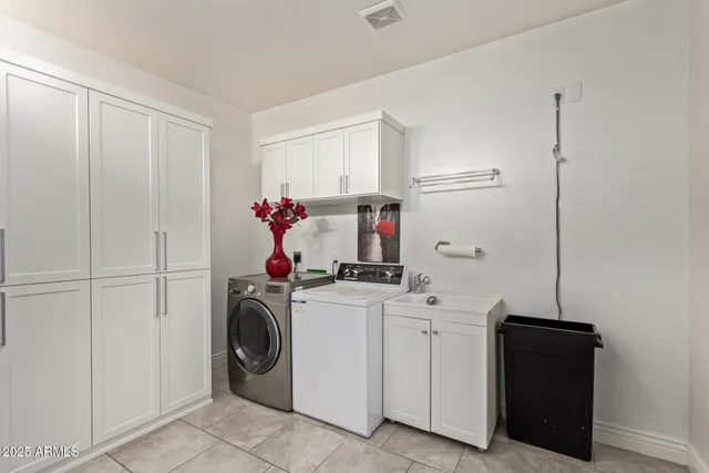 a view of a storage and utility room with washer and dryer