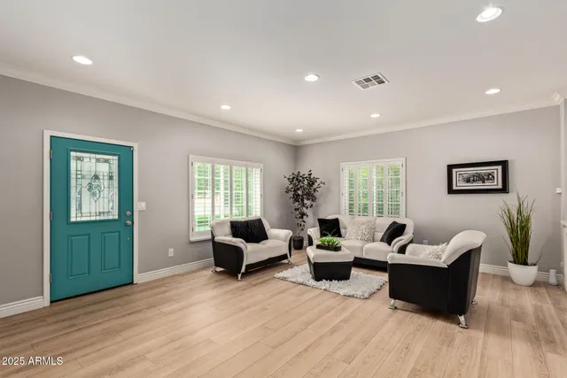 a living room with furniture and wooden floor