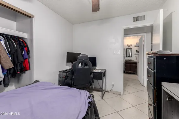 a bedroom with a bed and cabinets