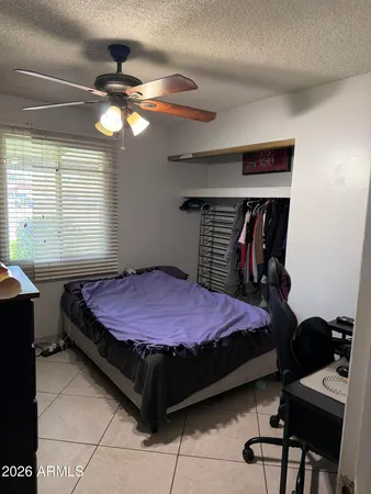 a bedroom with a bed and a window