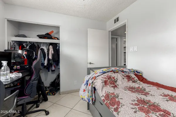 a bedroom with bed and a closet