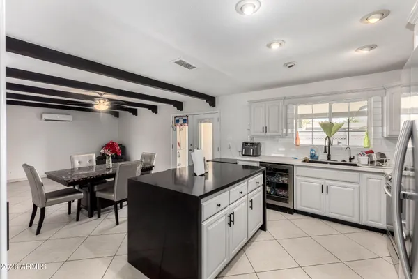 a kitchen with stainless steel appliances kitchen island granite countertop a sink and cabinets