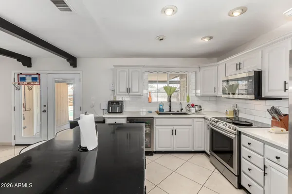 a kitchen with a sink stove and cabinets