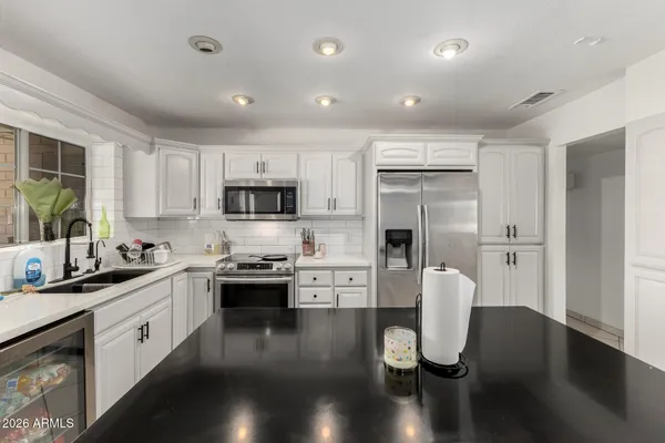 a kitchen with a sink stove and cabinets