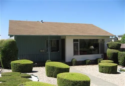 a view of house with backyard outdoor seating and green space