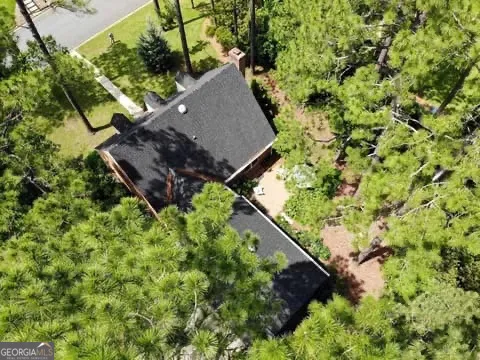 a front view of a house with a yard covered with snow