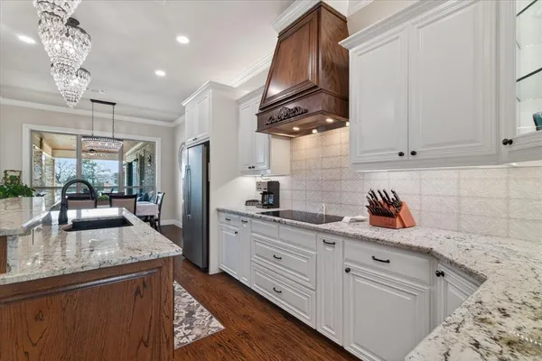 a kitchen with stainless steel appliances granite countertop a sink stove and cabinets