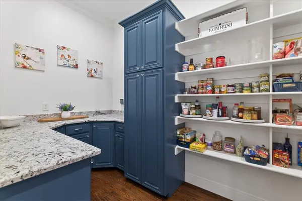 a view of kitchen cabinets with wooden floor