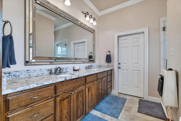 a bathroom with a double vanity sink and a mirror