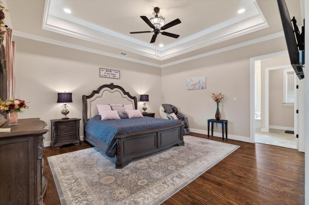 790 Bones Chapel Road Whitesboro, TX 76273 - Photo 17 of 40 a bedroom with a bed and a chandelier