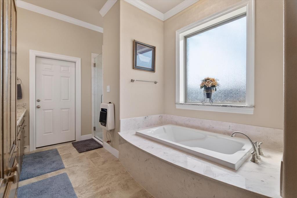 790 Bones Chapel Road Whitesboro, TX 76273 - Photo 19 of 40 a bathroom with a tub and a shower