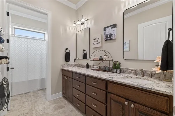 a bathroom with double vanity sinks a vanity and a mirror