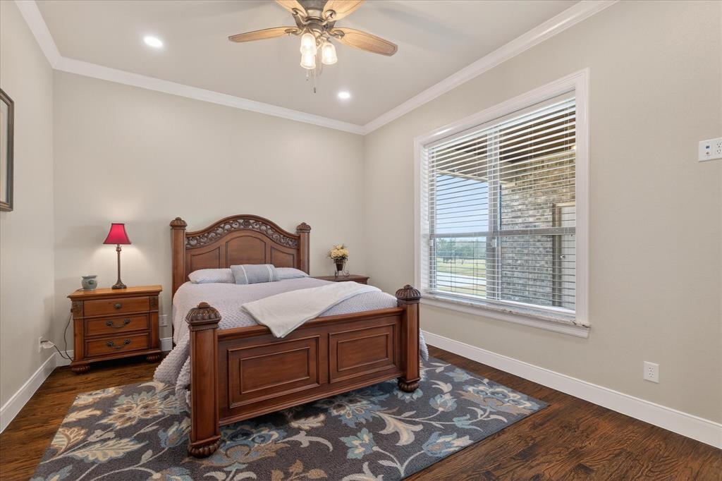 790 Bones Chapel Road Whitesboro, TX 76273 - Photo 21 of 40 a bedroom with a bed and a chandelier