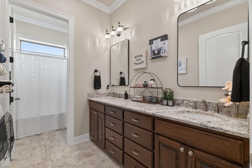 790 Bones Chapel Road Whitesboro, TX 76273 - Photo 22 of 40 a bathroom with double vanity sinks a vanity and a mirror