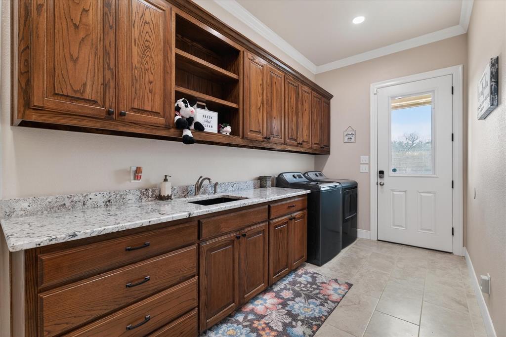 790 Bones Chapel Road Whitesboro, TX 76273 - Photo 28 of 40 a kitchen with stainless steel appliances granite countertop a sink dishwasher stove and cabinets with wooden floor