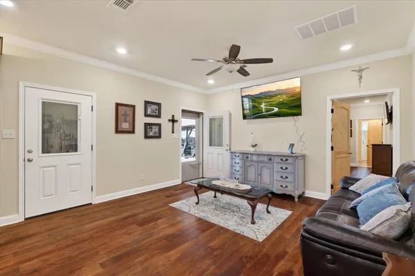 a living room with furniture and a flat screen tv