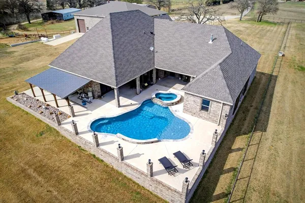 an aerial view of a house with swimming pool
