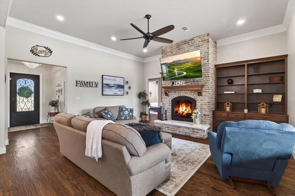 a living room with furniture a flat screen tv and a fireplace