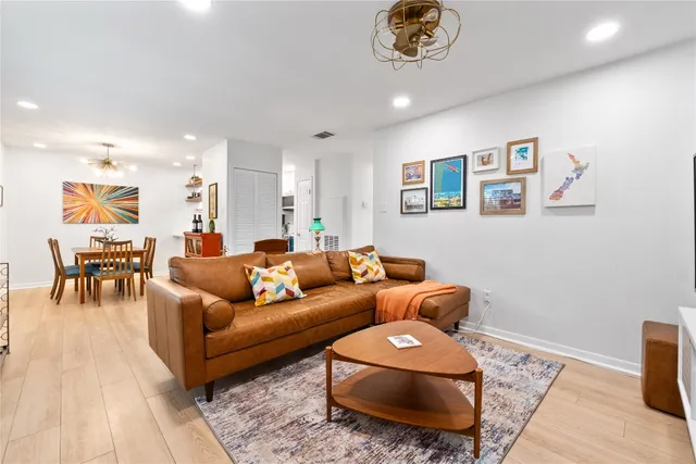 a living room with furniture and a chandelier
