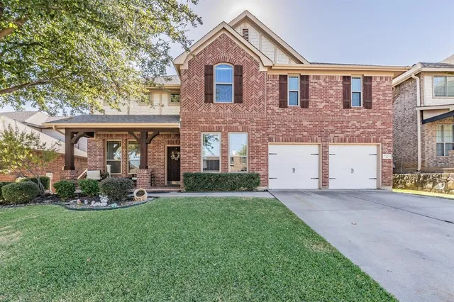 a front view of a house with a yard and porch
